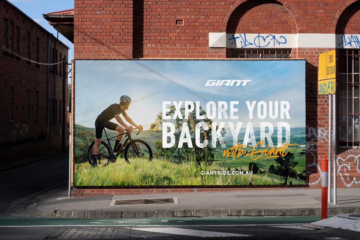Poster created by WOO Agency for Giant Bikes, featuring a man riding hide bike through an open field with the sun setting in the background
